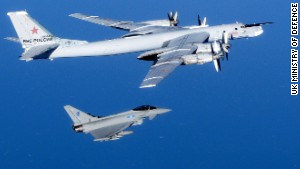 A Russian Tu-95 Bear bomber is escorted by a British Royal Air Force Typhoon fighter during an intercept in September 2014. Click through the gallery to see other intercepts in late 2014.