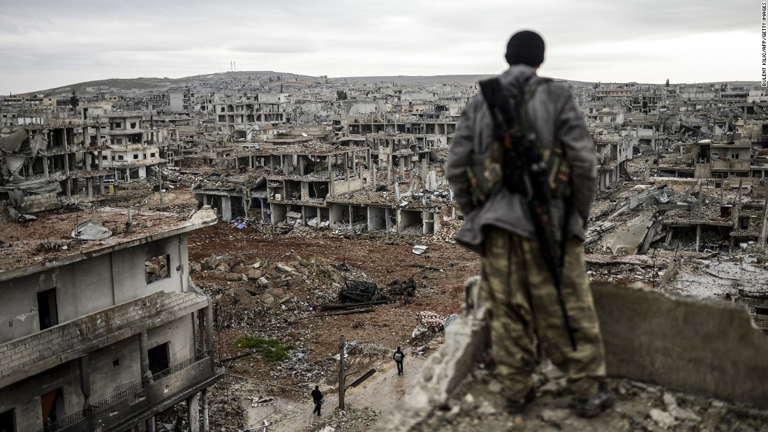 A Kurdish marksman looks over a destroyed area of Kobani, Syria, on Friday, January 30. Kobani, also known as Ayn al-Arab, had been under assault by ISIS since mid-September.