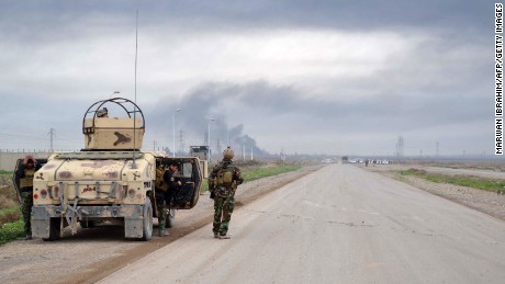 Smoke billows in Kirkuk as Kurdish Peshmerga fighters take position against ISIS militants on January 30.