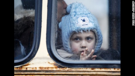 A child waits on a bus to leave Debaltseve on Tuesday, February 3, after increased fighting in the region.