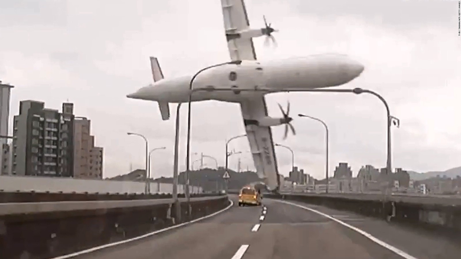 TransAsia Airways Flight GE235 clips a bridge in Taipei, Taiwan, shortly after takeoff Wednesday, February 4, in this still image taken from video. The ATR 72 twin-engine turboprop airplane then plunged into the Keelung River. More than 20 of the 58 passengers on board have been confirmed dead.
