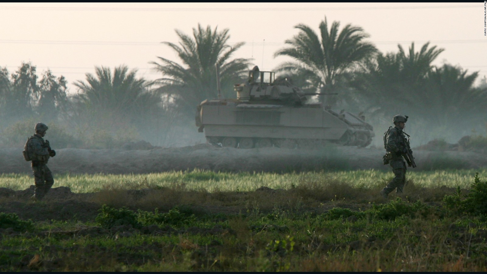 Smith (right) often patrolled Iraqi fields and roads laced with bombs but he preferred the sniper team.