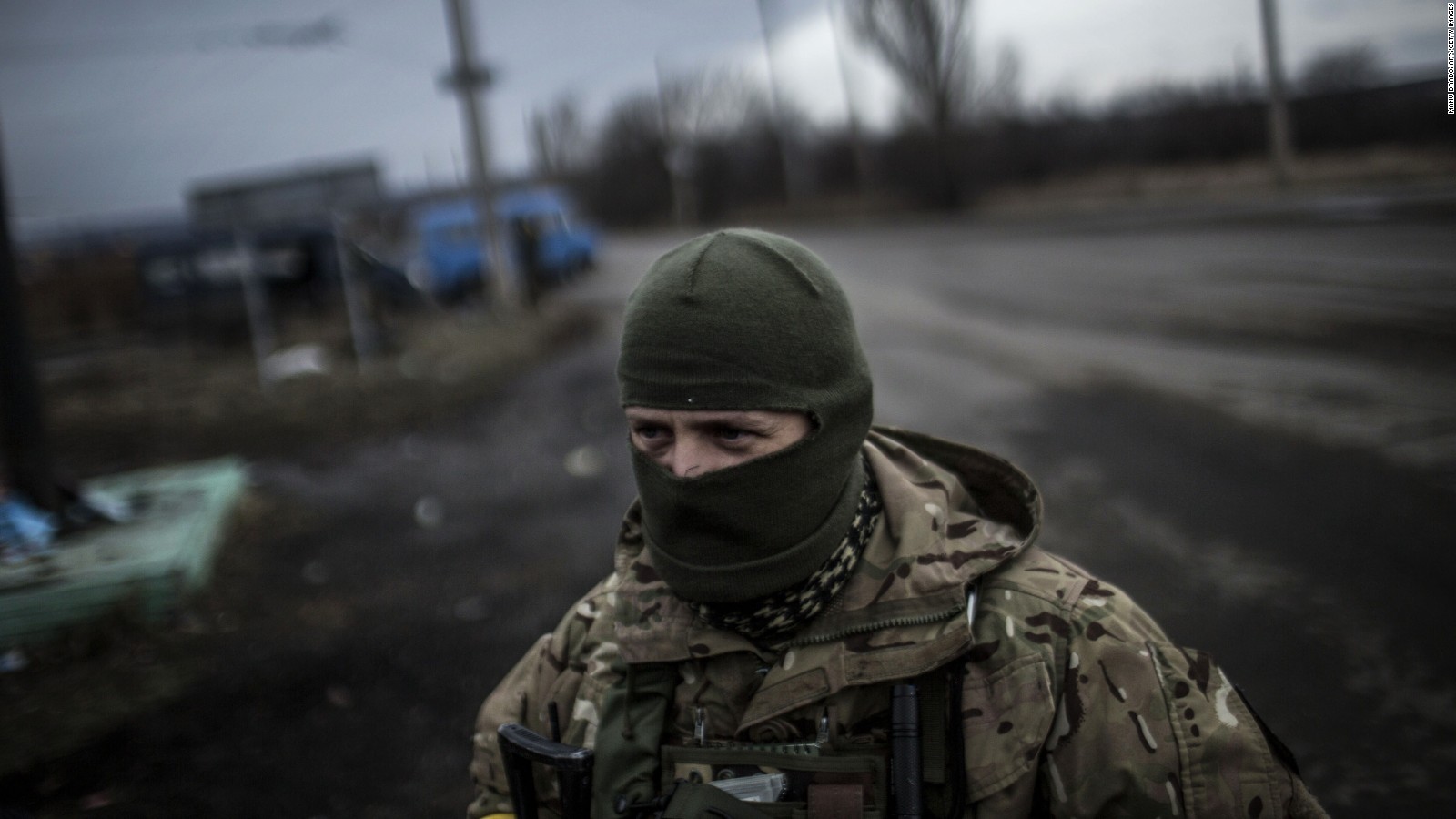 A Ukrainian soldier stands watch on a road between Debaltseve and the Ukrainian-controlled town of Artemivsk, in the Donetsk region, on February 2, 2015.