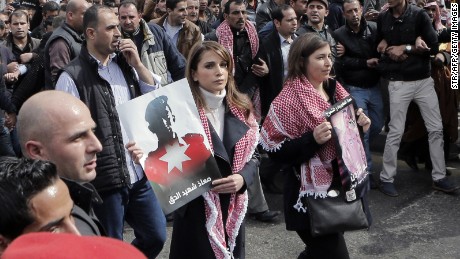 Jordanian Queen Rania, center, holds a placard during a demonstration in Amman, Jordan, on Friday, February 6, after the death of pilot Moath al-Kasasbeh by ISIS. Al-Kasasbeh was burned alive in a video recently released by ISIS militants.