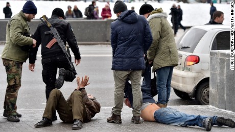 Ukrainian volunteer fighters and policemen arrest two men in Kiev, Ukraine, on February 9. The men allegedly arrived from Donetsk and were suspected of participating in pro-Russian rebel activities and organizing terrorist attacks in the Ukrainian capital.