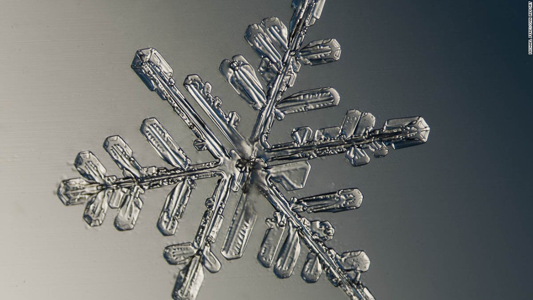 To capture different colors, he uses newspapers, envelopes and other items as a backdrop for the snowflake.