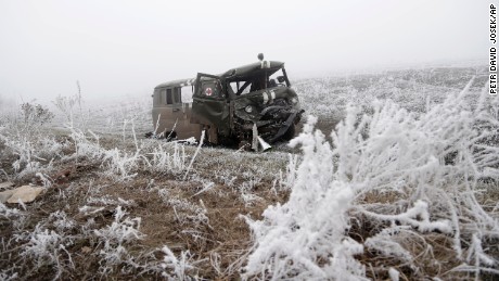 An army ambulance damaged in recent shelling lies by a road near Svitlodarsk, Ukraine, on Sunday, February 15.