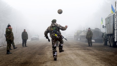Ukrainian servicemen play with a soccer ball on a road between Svitlodarsk and Debaltseve on February 15.