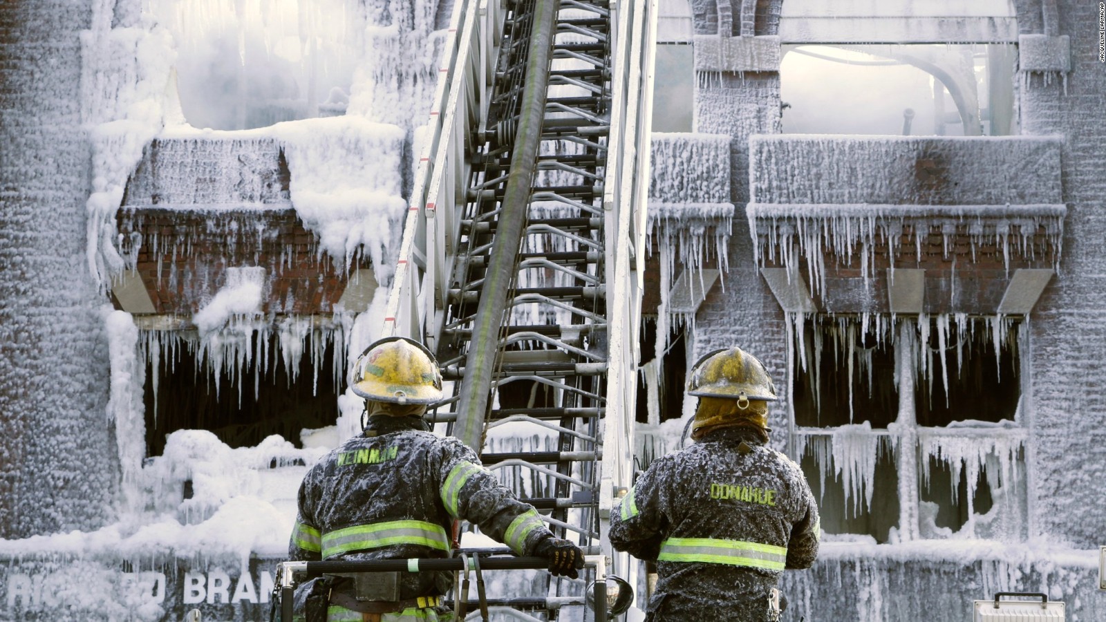 Philadelphia firefighters work the scene of an overnight blaze in west Philadelphia, Monday Feb. 16, 2015, as icicles hang from where the water from their hoses froze. Bone-chilling, single digit temperatures have gripped the region, prompting the closure of all parish and regional Catholic elementary schools in the city of Philadelphia. (AP Photo/Jacqueline Larma)