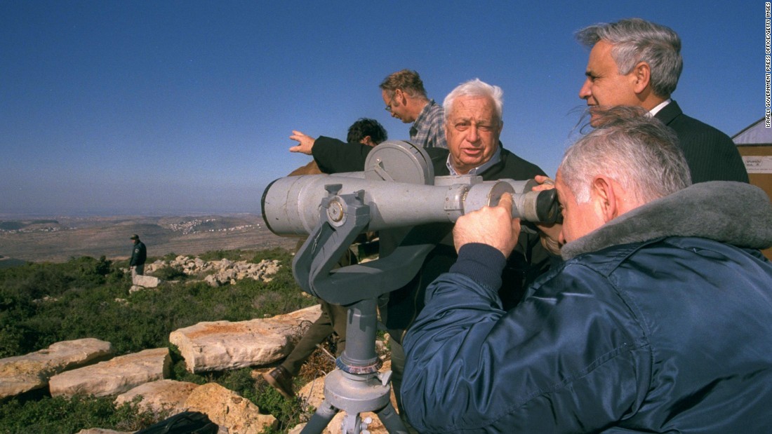 Netanyahu looks through binoculars during a tour of the West Bank with the Israeli Cabinet on December 28, 1997. 