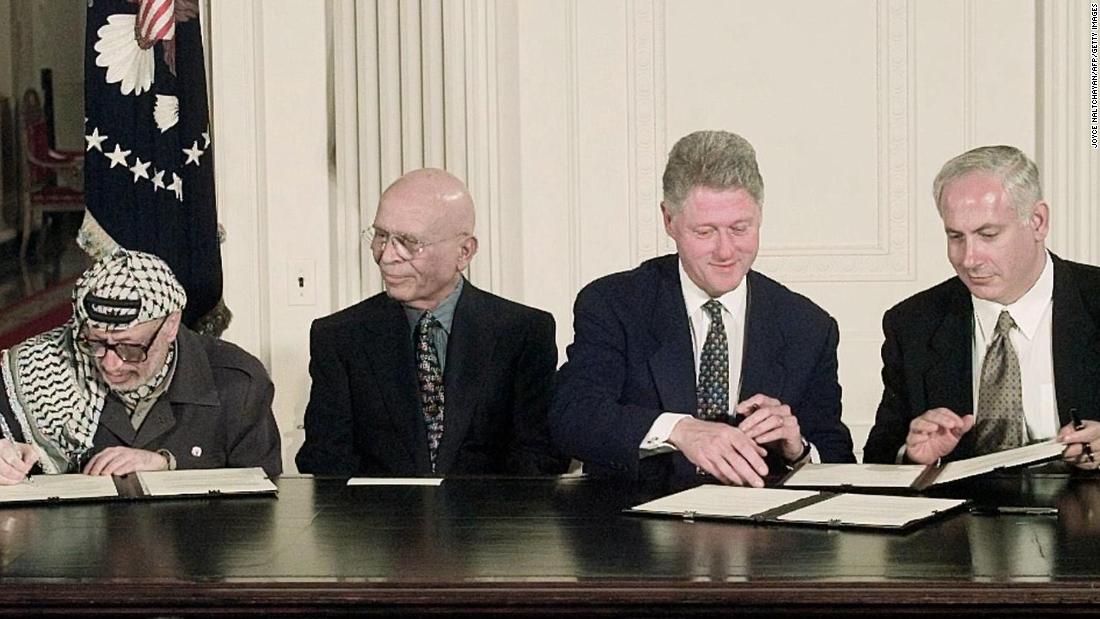 From left, Arafat, King Hussein, U.S. President Bill Clinton and Netanyahu sign an interim Middle East peace agreement in October 1998.