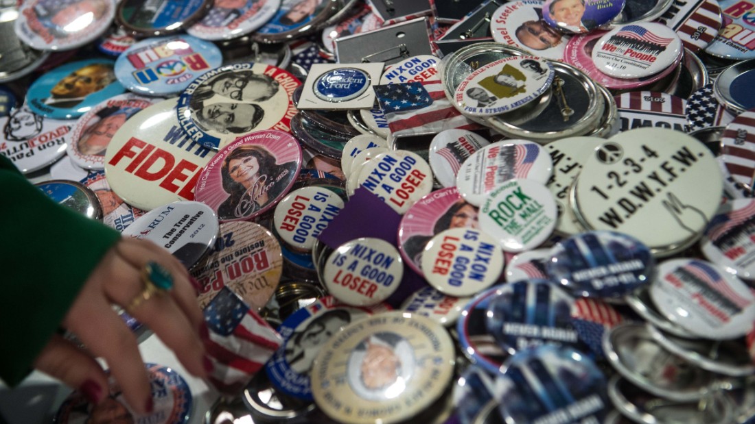 A woman browses through conservative politicas badges at the annual Conservative Political Action Conference.