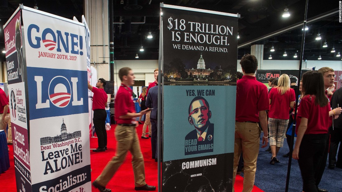 Volunteers walk by a stand at the annual Conservative Political Action Conference.