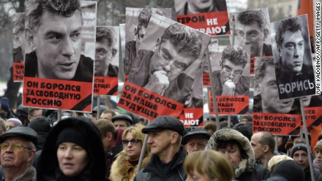 Russia&#39;s opposition supporters carry portraits of Kremlin critic Boris Nemtsov during a march in central Moscow on March 1, 2015. The 55-year-old former first deputy prime minister under Boris Yeltsin was shot in the back several times just before midnight on February 27 as he walked across a bridge a stone&#39;s throw from the Kremlin walls.