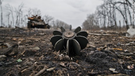 A mortar round sticks out of the ground near a destroyed tank at a former Ukrainian army checkpoint outside Chornukhyne, Ukraine, on Monday, March 2. Russian-backed separatists had recently overran the area.
