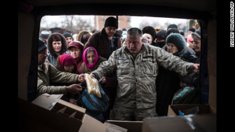 A volunteer gives humanitarian aid to residents of Popasna, Ukraine, on Saturday, February 28.