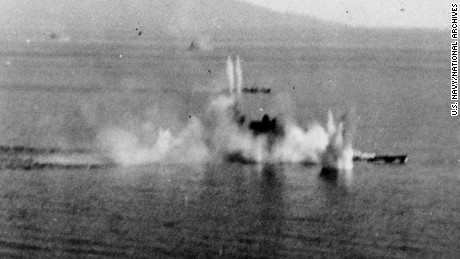 The Japanese battleship Musashi under intense attack by Task Force 38 aircraft in the Sibuyan Sea. A destroyer is also receiving attacks beyond the battleship.