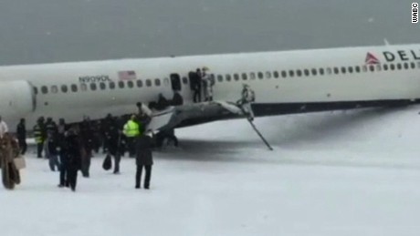 Delta flight skids off LaGuardia runway, stops feet from frigid.