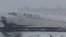 Delta flight skids off LaGuardia runway, stops feet from frigid.