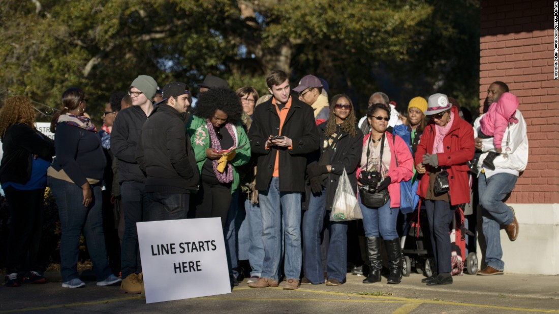 People wait in line to attend an anniversary event, where President Obama is scheduled to speak, at the Edmund Pettus Bridge.