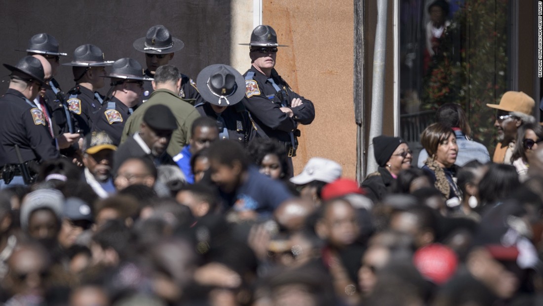 Police watch over the crowd waiting on Broad Street in Selma, Alabama.