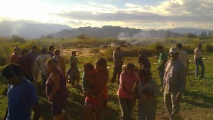 An image from the scene shows people gathering near the smoking wreckage. 