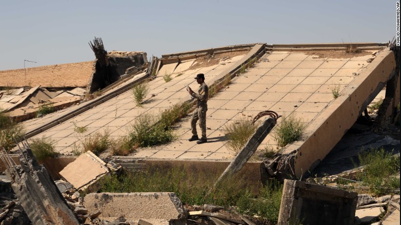 An Iraqi soldier takes photos of the &lt;a href=&quot;http://www.cnn.com/2015/03/16/middleeast/iraq-isis-babylon-safe/index.html&quot; target=&quot;_blank&quot;&gt;demolished tomb of former Iraqi President Saddam Hussein&lt;/a&gt; on Sunday, March 15. The tomb in Tikrit was destroyed as Iraqi forces battled ISIS for control of the city.