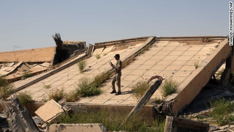 An Iraqi soldier takes photos of the <a href="http://www.cnn.com/2015/03/16/middleeast/iraq-isis-babylon-safe/index.html" target="_blank">demolished tomb of former Iraqi President Saddam Hussein</a> on Sunday, March 15. The tomb in Tikrit was destroyed as Iraqi forces battled ISIS for control of the city.