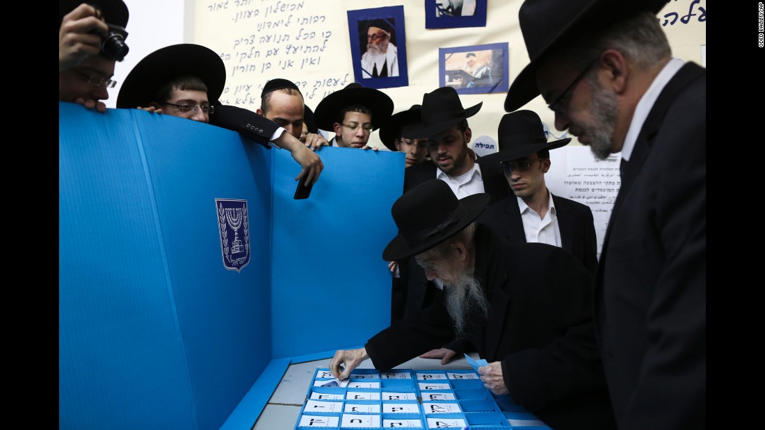 Rabbi Gershon Edelstein, center, prepares to vote in Bnei Brak, Israel, on March 17.