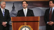 Rubio, center, speaks to members of the media as Sen. Ron Johnson, left, and Rep. Ron DeSantis listen during a news conference on Capitol Hill in October 2013.