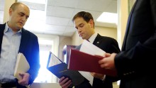Rubio talks to aides in December before speaking on President Barack Obama's announcement about revising policies on U.S.-Cuba relations.