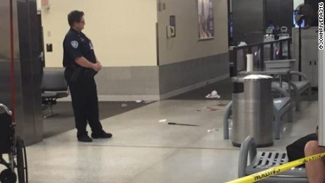 The machete allegedly used against TSA officers is seen on the floor of the airport.