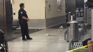 The machete allegedly used against TSA officers is seen on the floor of the airport.