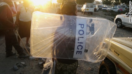 A man in Aden holds a police shield that he looted from a base belonging to forces loyal to former Yemeni President Ali Abdullah Saleh on Thursday, March 19. Some of the forces aligned with the Houthis also are loyal to Saleh, who resigned in 2012 after months of "Arab Spring" protests.