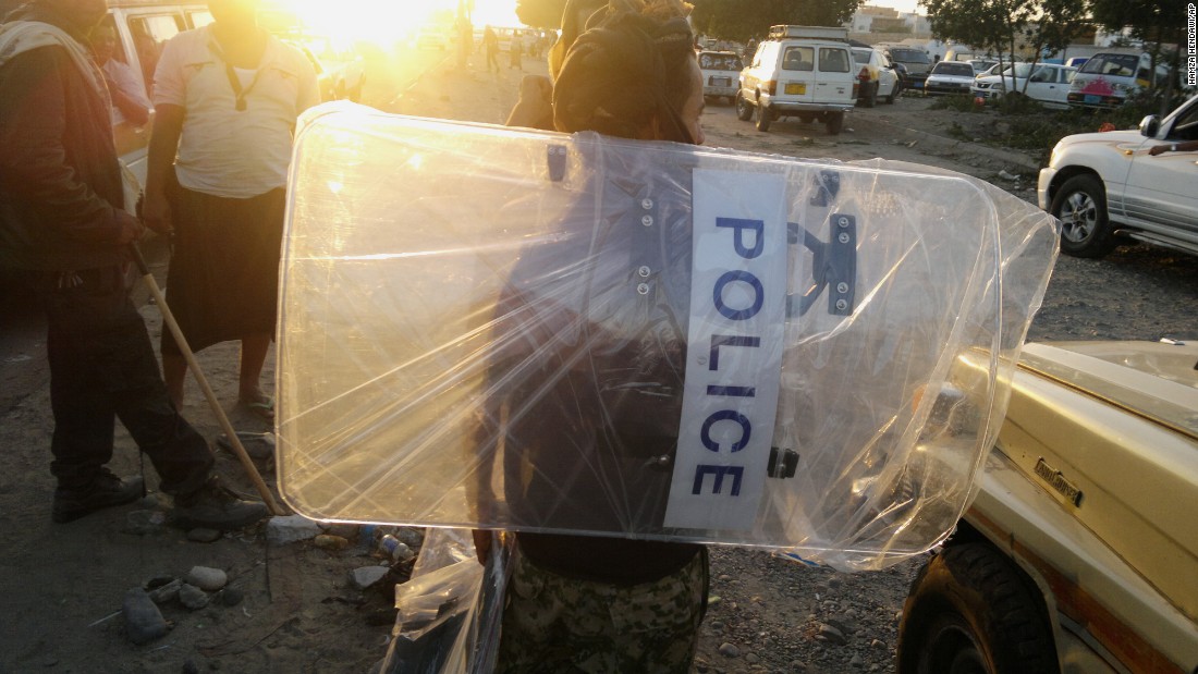 A man in Aden holds a police shield that he looted from a base belonging to forces loyal to former Yemeni President Ali Abdullah Saleh on Thursday, March 19. Some of the forces aligned with the Houthis also are loyal to Saleh, who resigned in 2012 after months of &quot;Arab Spring&quot; protests.