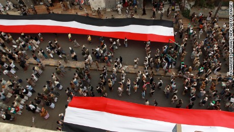 Houthi supporters in Sanaa deploy giant national flags Wednesday, March 18, during a demonstration to mark the fourth anniversary of the "Friday of Dignity" attack. In 2011, forces loyal to Saleh <a href="http://www.cnn.com/2011/10/15/world/meast/yemen-unrest/" target="_blank">opened fire on protesters</a> who had gathered in Sanaa to demand the ouster of Saleh and his regime.