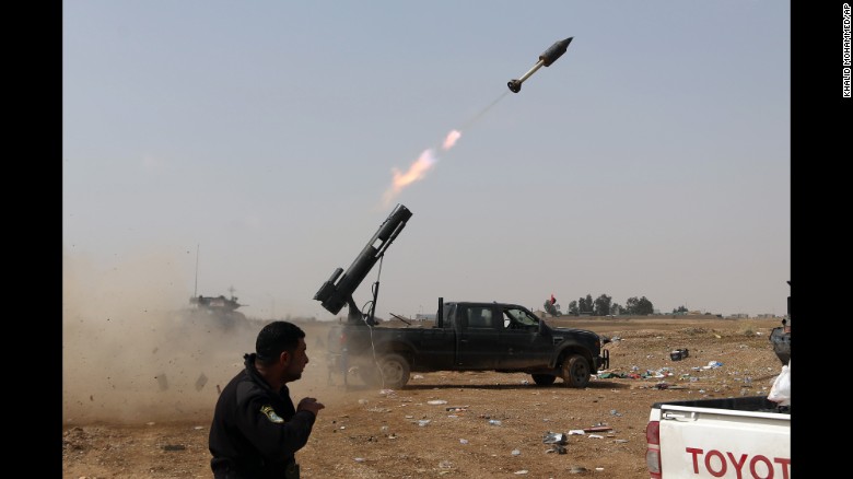 Iraqi security forces launch a rocket against ISIS positions in Tikrit on Monday, March 30.