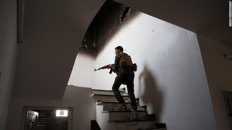 An Iraqi soldier searches for ISIS fighters in Tikrit on March 30.