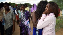 Students mourn in Garissa, Kenya, on Friday, April 3. At least 147 people were killed a day earlier when gunmen stormed Garissa University College before dawn, officials said. The Somalia-based Al-Shabaab militant group claimed responsibility for the assault.
