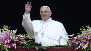 Pope Francis greets the crowd from St. Peter&#39;s Basilica at the Vatican on Sunday.