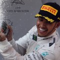 Mercedes AMG Petronas F1 Team&#39;s British driver Lewis Hamilton (L) sprays champagne as he celebrates his victory on the podium after winning the Formula One Chinese Grand Prix in Shanghai on April 12, 2015. AFP PHOTO / JOHANNES EISELE (Photo credit should read JOHANNES EISELE/AFP/Getty Images)