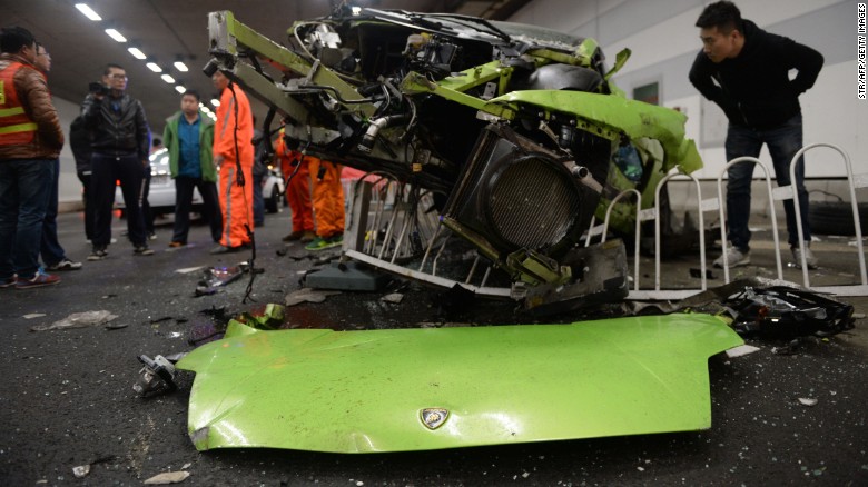Police investigate the wreckage of the totaled Lamborghini. 