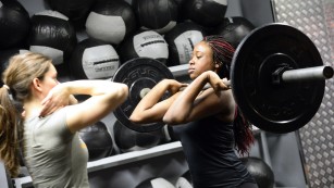 A woman lifts weight during a crossfit training in a gym in Paris on January 16, 2015. AFP PHOTO / BERTRAND GUAY (Photo credit should read BERTRAND GUAY/AFP/Getty Images)