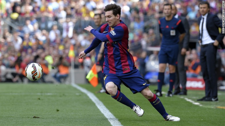 Lionel Messi dances around the Nou Camp touchline as Barcelona face Valencia.