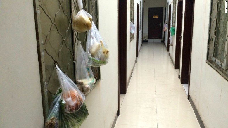 Bags of produce hang on the window frames each room. Many guests use communal kitchen to cut costs. 