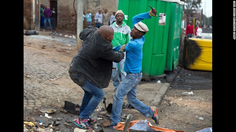 Mozambican Emmanuel Sithole, left, was walking down a street in Johannesburg&#39;s Alexandra Township when four men surrounded him on Saturday, April 18. Sithole pleaded for mercy, but it was already too late. The attackers bludgeoned him with a wrench and stabbed him with knives, killing him in broad daylight. Photographer James Oatway was nearby and captured it all on his camera.