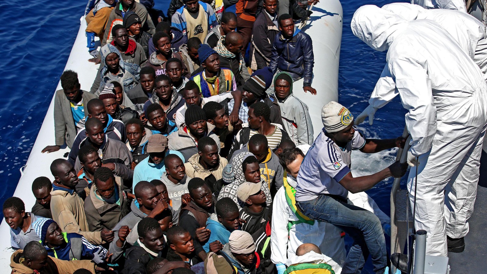 In this photo made available Thursday, April 23, 2015, migrants crowd and inflatable dinghy as rescue vassel " Denaro " of the Italian Coast Guard approaches them, off the Libyan coast, in the Mediterranean Sea, Wednesday, April 22, 2015. European Union leaders gathering for an extraordinary summit are facing calls from all sides to take emergency action to save lives in the Mediterranean, where hundreds of migrants are missing and feared drowned in recent days. (Alessandro Di Meo/ANSA via AP Photo) ITALY OUT