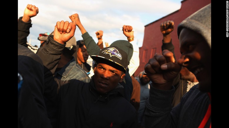 Demonstrators put their fists in the air during a protest outside the Baltimore police's Western District station on Wednesday, April 22.