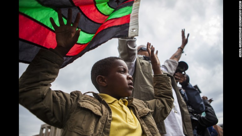People march through the streets of Baltimore on April 22.
