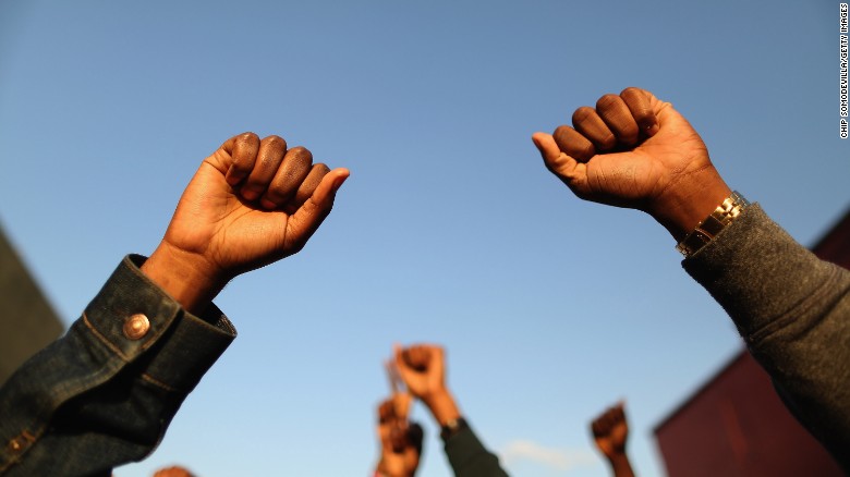 Demonstrators put their fists in the air during the protest on April 22.